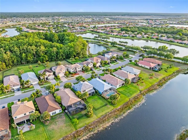 Aerial overview of property's location with a nearby body of water and nearby suburban area