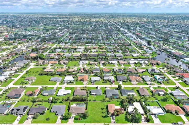 View of property location with a nearby body of water and nearby suburban area