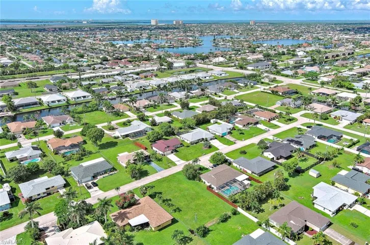 Aerial overview of property's location with a large body of water and nearby suburban area