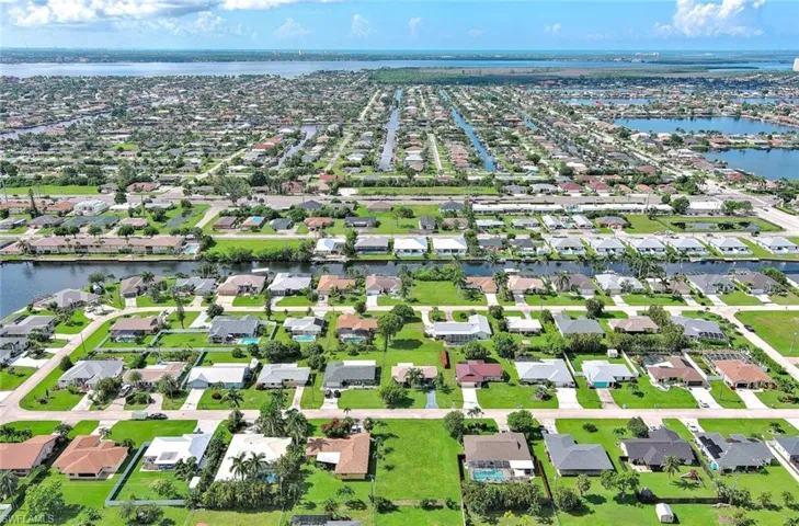 Aerial view of residential area featuring a large body of water