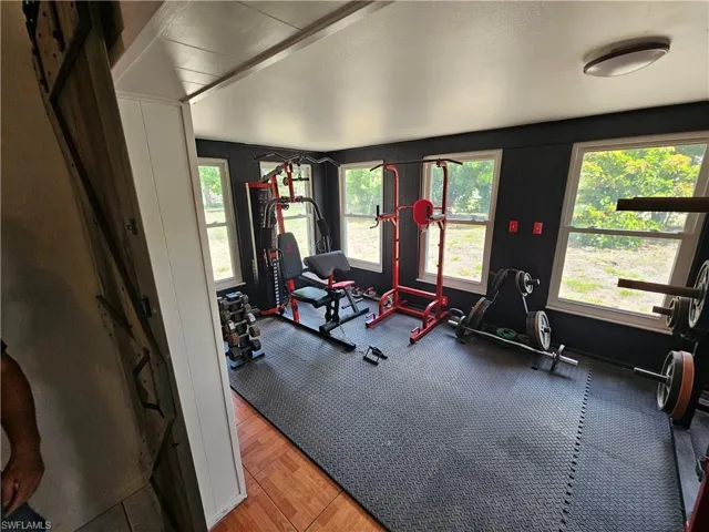 Workout area featuring plenty of natural light and a textured ceiling