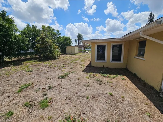 View of yard with a storage unit