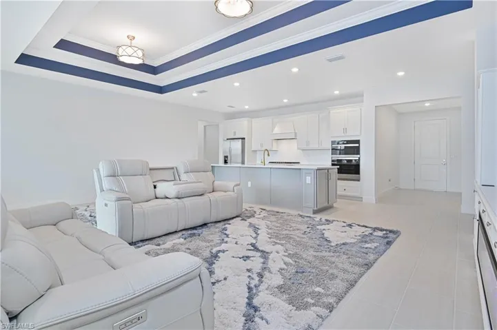 Living room featuring ornamental molding and a tray ceiling