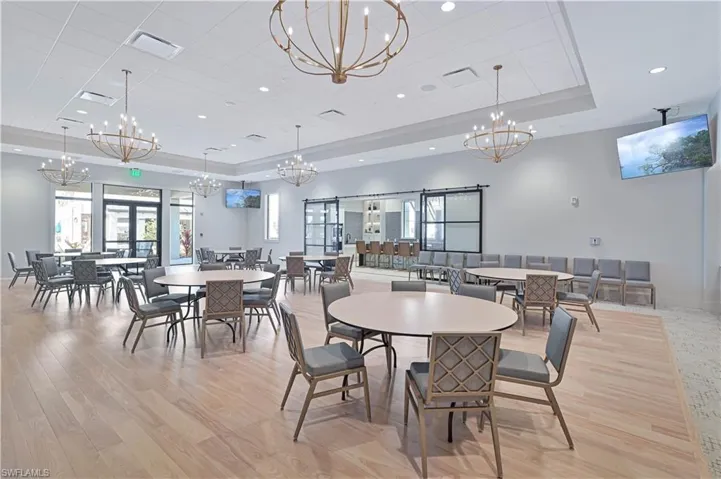 Dining area featuring light wood-type flooring, a tray ceiling, recessed lighting, and plenty of natural light
