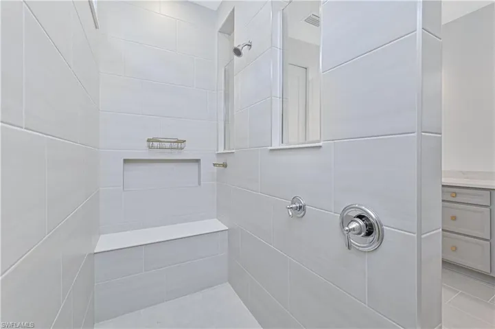 Bathroom with a tile shower and vanity