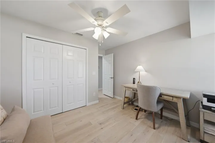 Office space featuring light wood finished floors and a ceiling fan