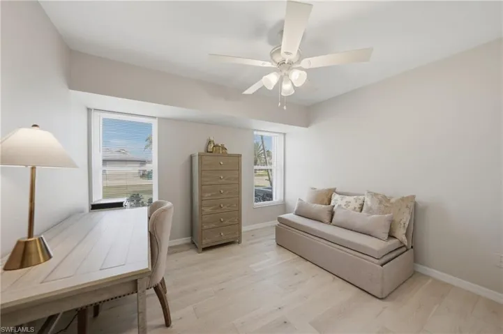 Office area featuring light wood-style floors and a ceiling fan