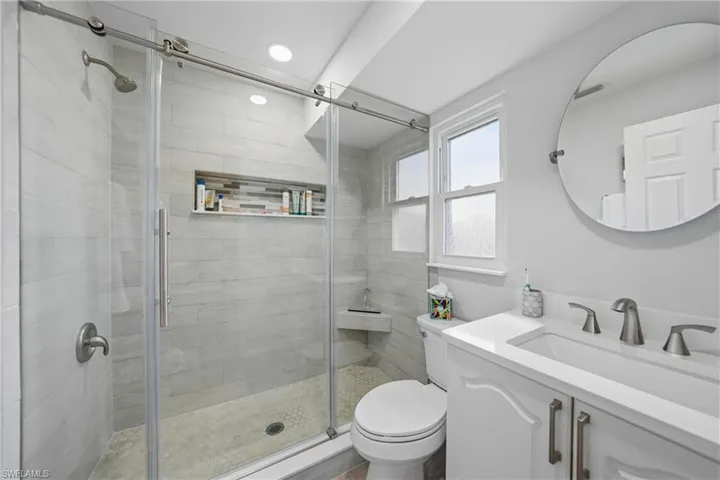 Bathroom with vanity and a stall shower