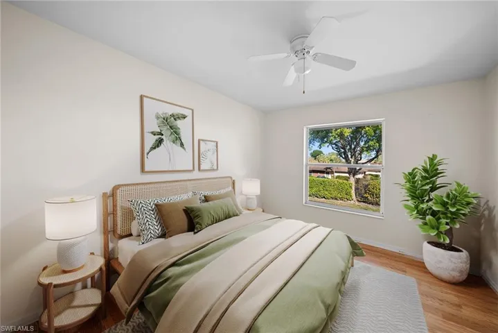 Bedroom featuring wood finished floors and a ceiling fan