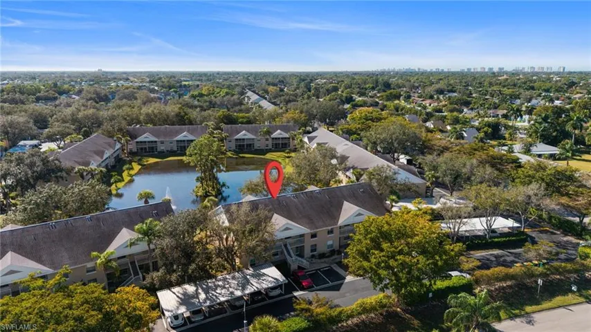 Drone / aerial view of apartment complex and a large body of water