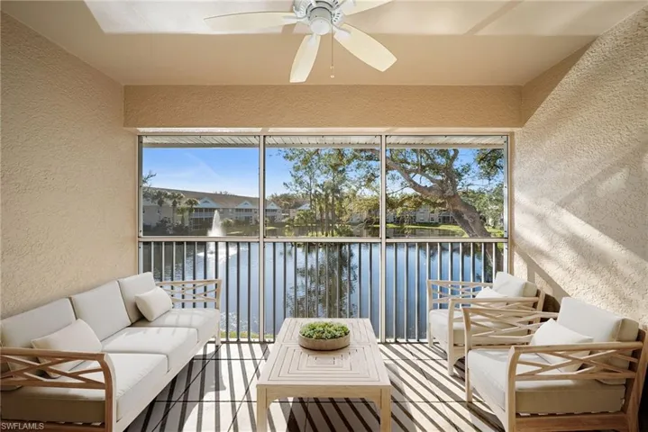 Sunroom / solarium with plenty of natural light and a water view