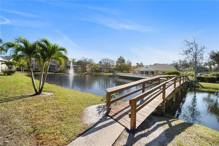 Dock with a water view, a yard, and a residential view