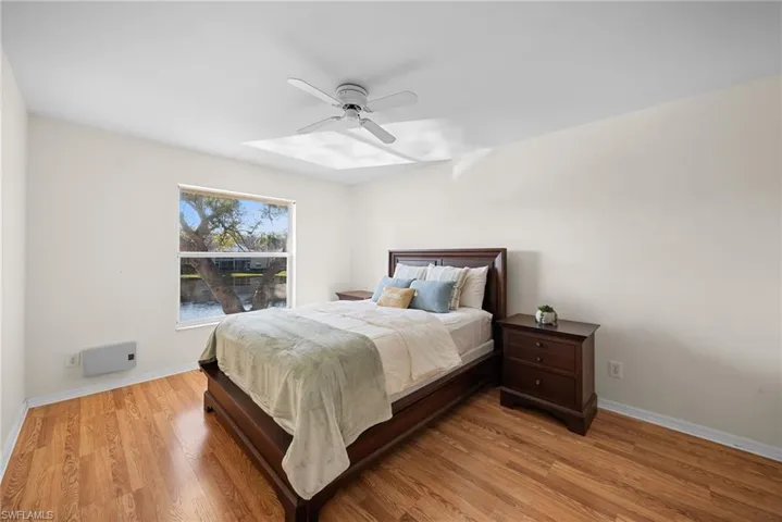 Bedroom with light wood-style floors and ceiling fan