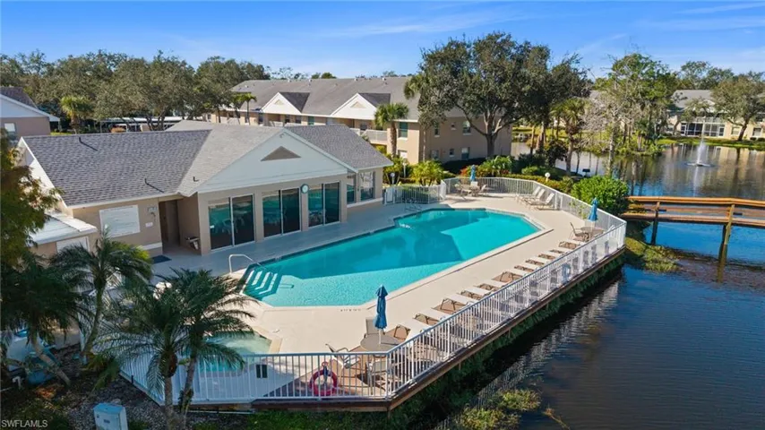 Community pool featuring a patio and a water view