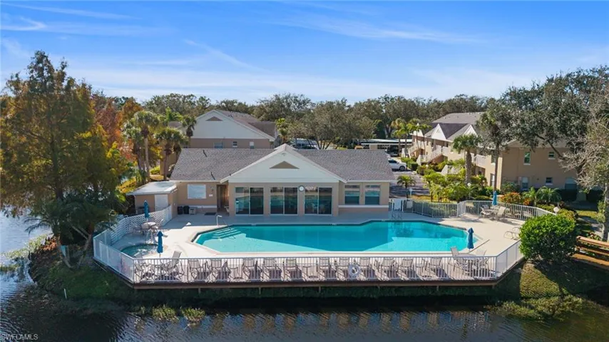 Community pool featuring a patio and a water view