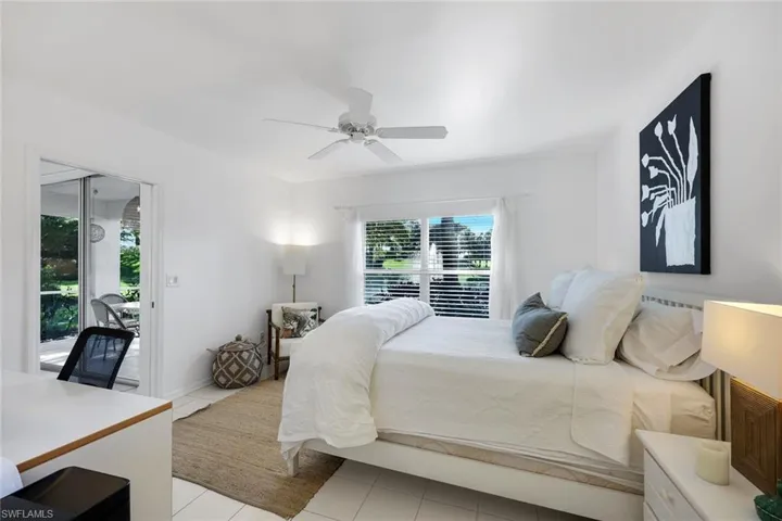 Sliding glass doors, ceiling fan, and ceramic tile flooring