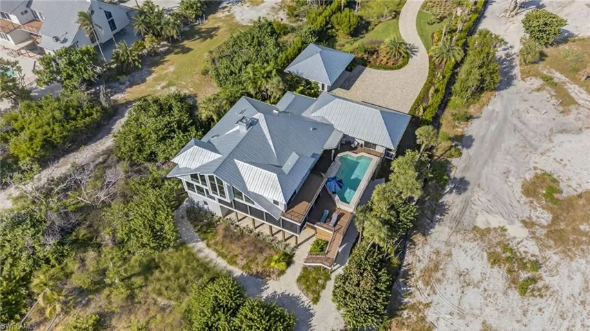 Aerial view of property and surrounding area featuring a pool area