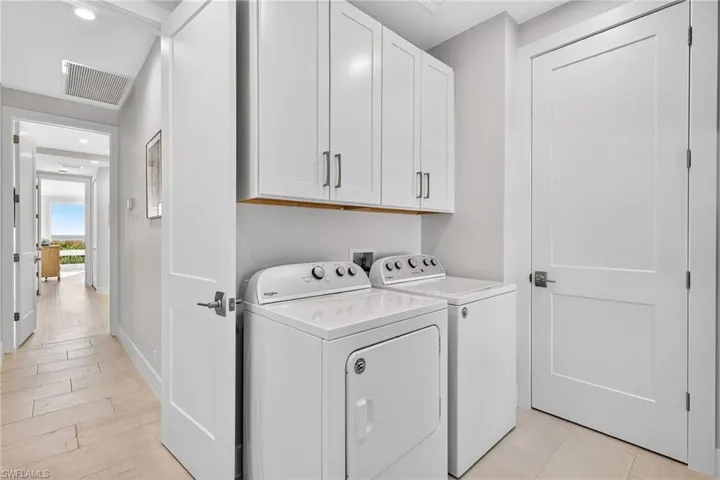 Laundry room featuring cabinet space, washing machine and dryer, and recessed lighting