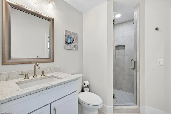 Full bathroom featuring vanity, a shower stall, and light tile patterned flooring