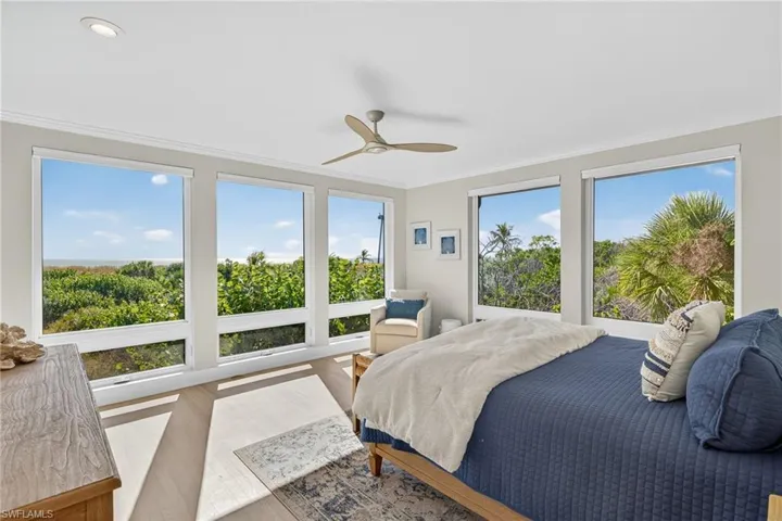 Bedroom featuring crown molding, wood finished floors, and a ceiling fan
