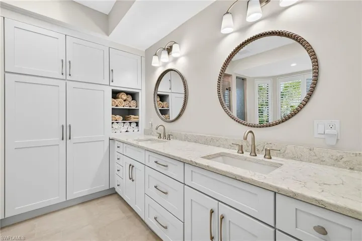 Full bath featuring double vanity