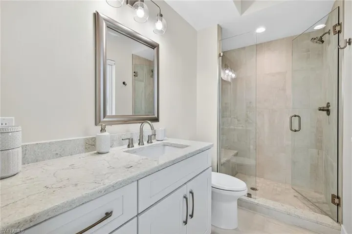 Bathroom featuring vanity, a shower stall, and recessed lighting