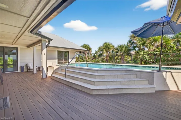 Wooden terrace featuring a patio