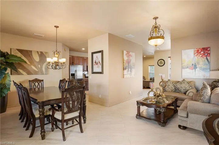Dining area with an inviting chandelier, baseboards, visible vents, and recessed lighting