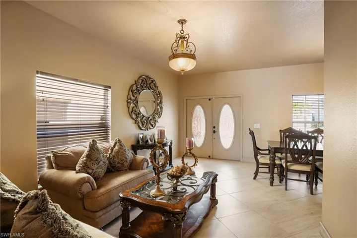 Living area featuring light tile patterned floors and french doors