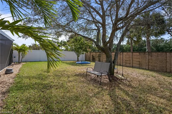 View of yard featuring a fenced backyard and a trampoline
