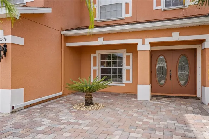 View of exterior entry featuring stucco siding