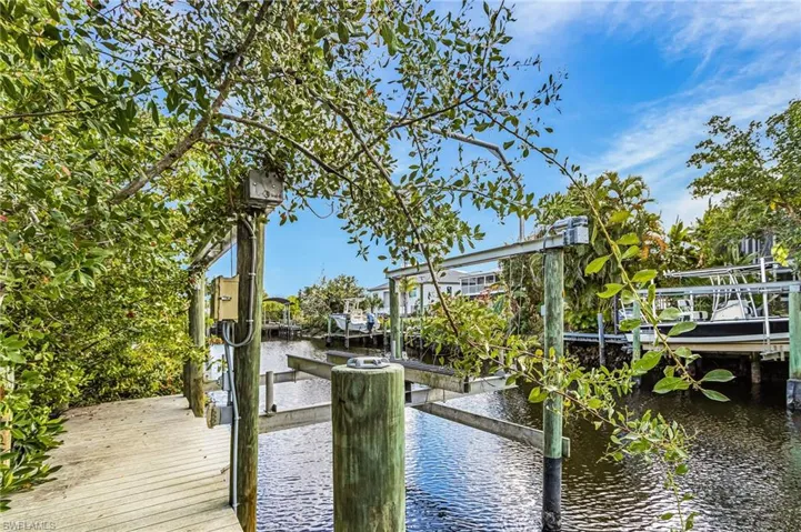 Dock area with boat lift and a water view