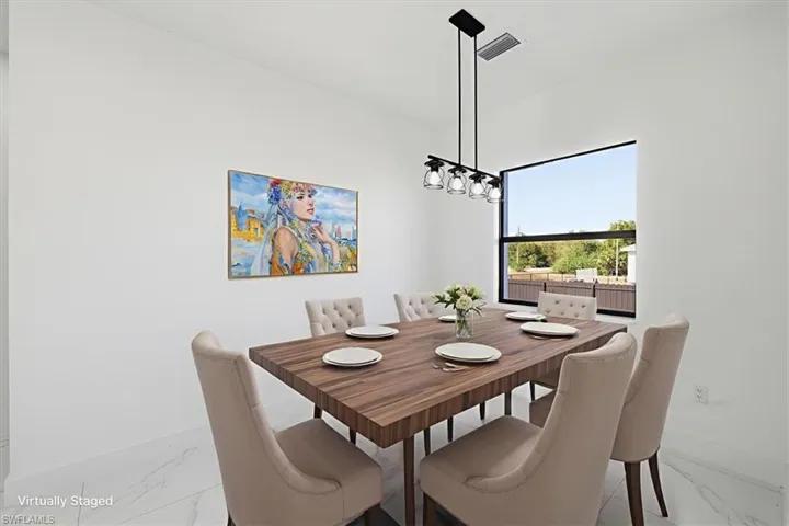 Dining room with light marble finish flooring and baseboards
