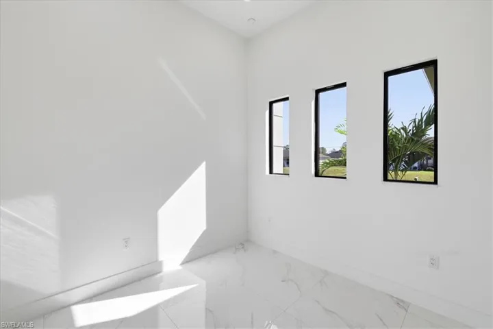 Unfurnished room with marble finish flooring and baseboards