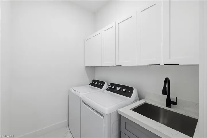 Washroom with washing machine and dryer and cabinet space