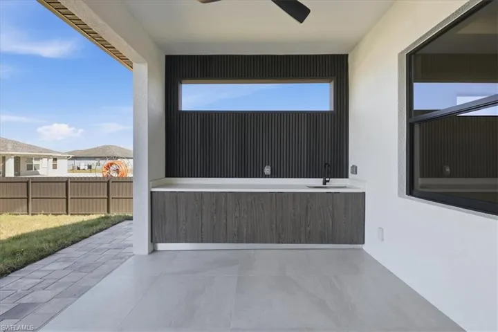View of patio with ceiling fan and a sink