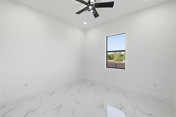 Spare room with light marble finish floors, recessed lighting, and a ceiling fan