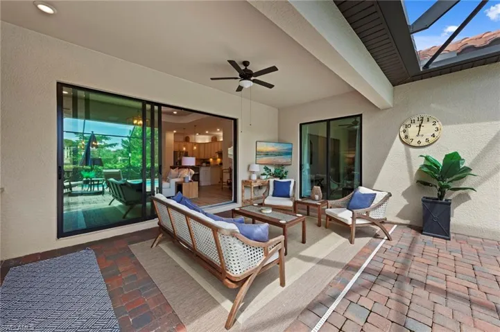 View of patio with a ceiling fan and an outdoor hangout area