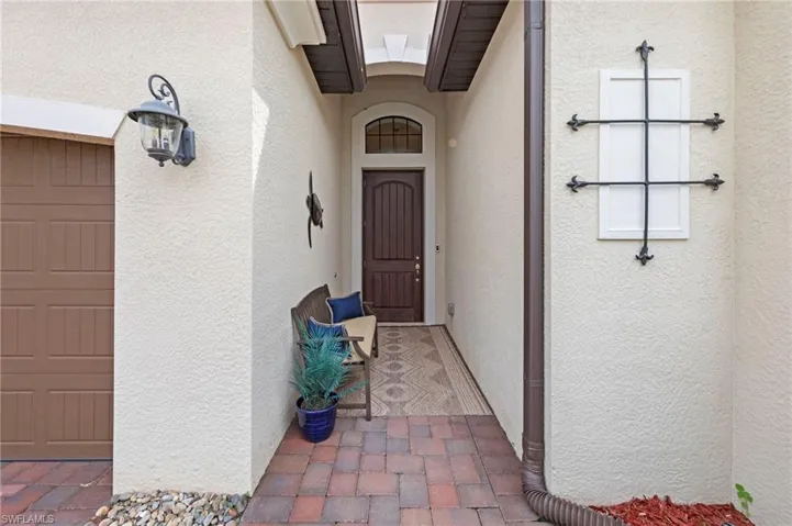 Entrance to property with stucco siding