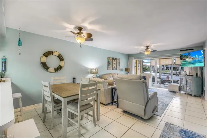Tiled dining room with ceiling fan