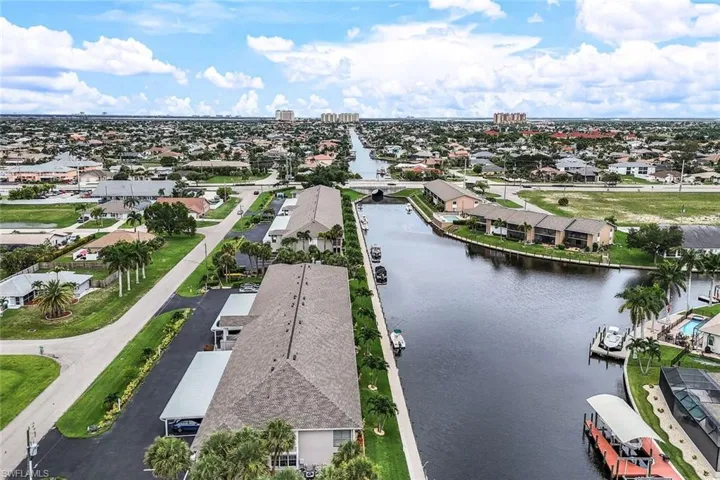 Birds eye view of property with a water view