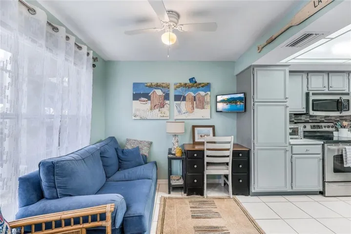 Tiled living room featuring ceiling fan