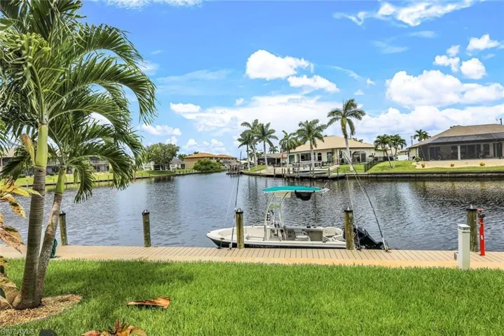 Dock area featuring a water view and a yard