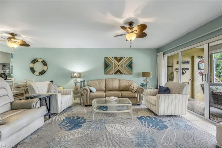 Tiled living room featuring ceiling fan