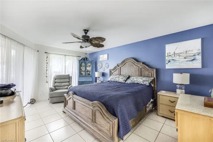 Bedroom featuring ceiling fan and light tile floors