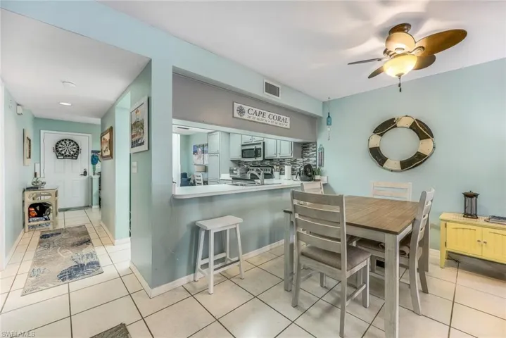 Dining area featuring ceiling fan and light tile floors