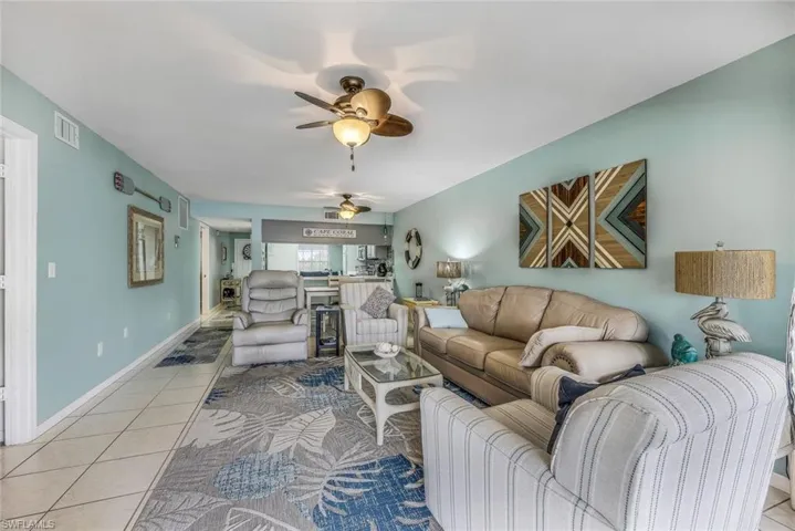 Tiled living room featuring ceiling fan