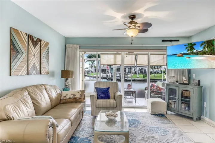Tiled living room featuring ceiling fan