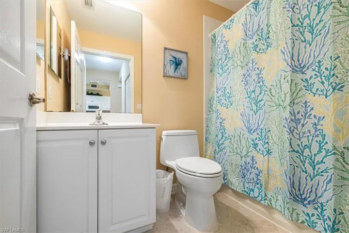 Full bath featuring vanity and light tile patterned floors