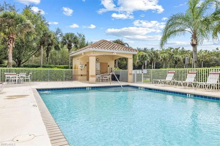 Community pool with a patio area, a gazebo, and view of scattered trees